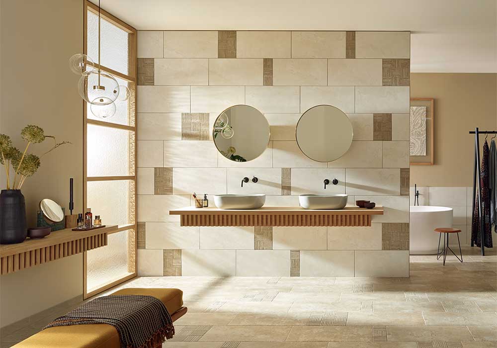 Holzmöbel und Doppelwaschtisch mit runden Spiegeln an einer Wand mit Fliesen von AGROB BUCHTAL